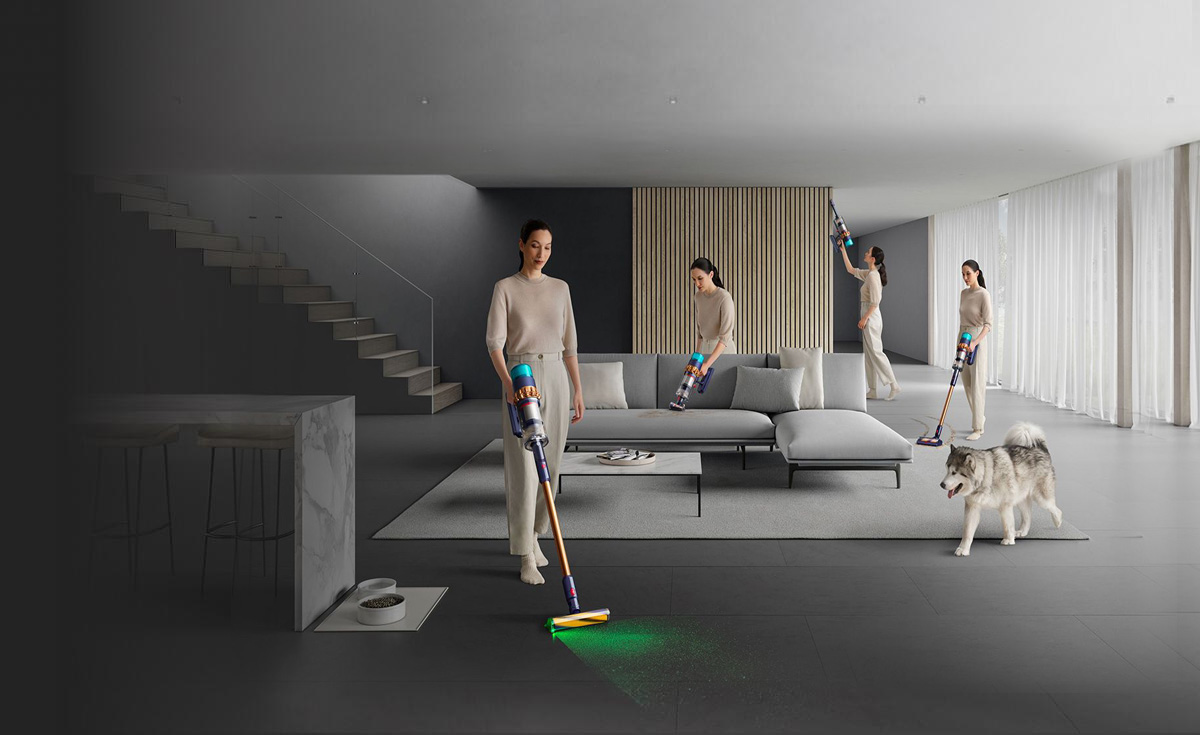 Woman cleaning all around room, up high, on sofa, carpet and hard floor.